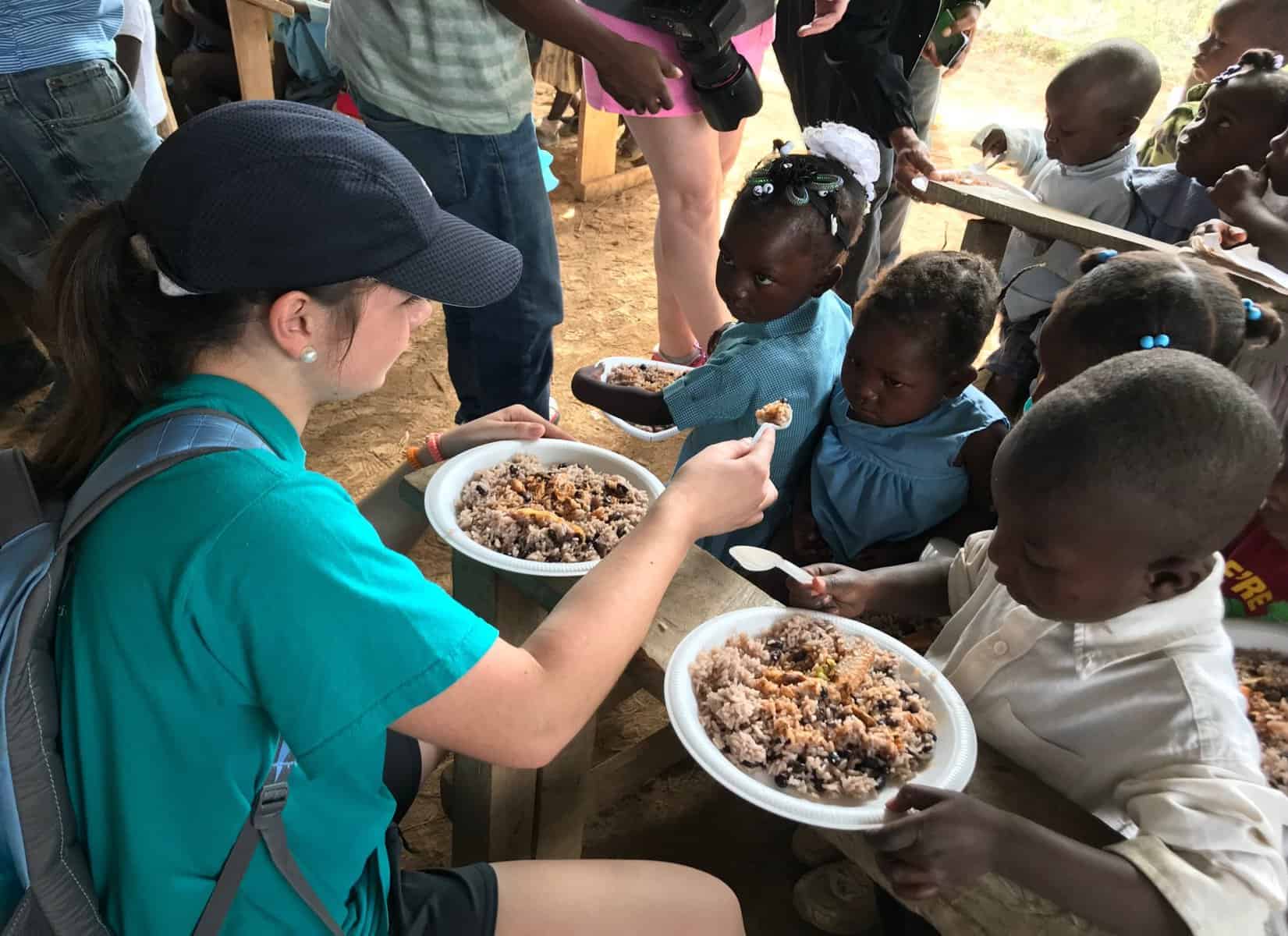 Children receiving meals at a CFAM ministry activity