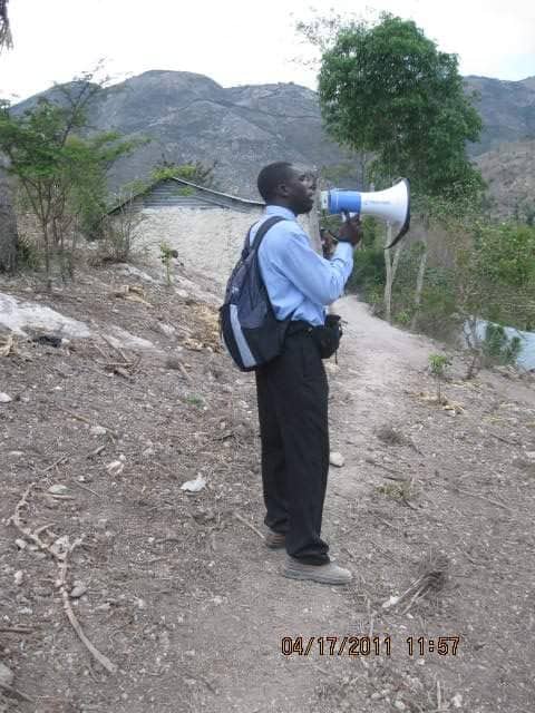 Rene Romil sharing the gospel outdoors through a megaphone