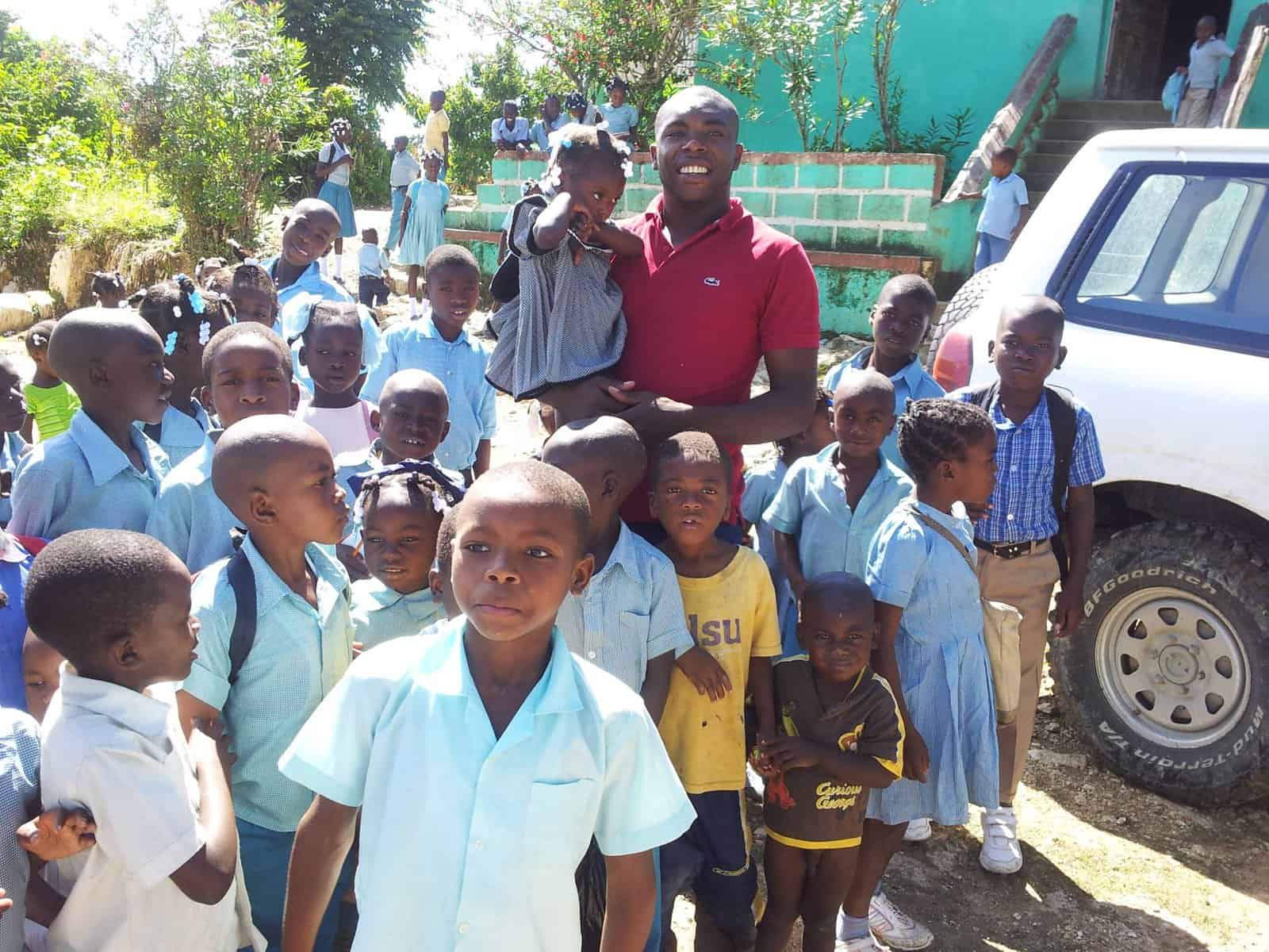 Rene Romil with a group of children